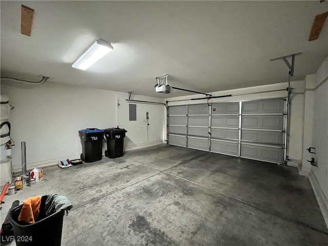 garage with a garage door opener and electric panel