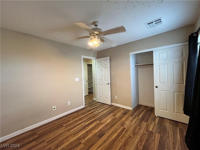 unfurnished bedroom featuring dark wood finished floors, a closet, visible vents, ceiling fan, and baseboards