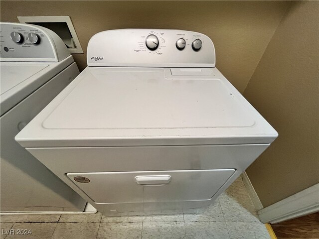 clothes washing area with washer and clothes dryer