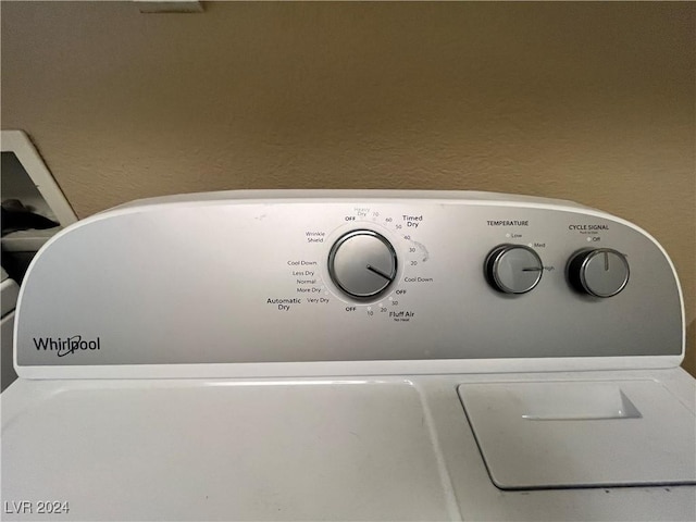 details featuring washer / clothes dryer and a textured wall