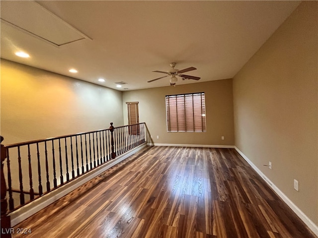 unfurnished room featuring ceiling fan and dark hardwood / wood-style flooring