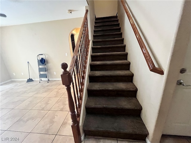 stairs featuring tile patterned floors