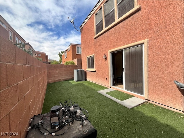 view of yard featuring central AC and a fenced backyard