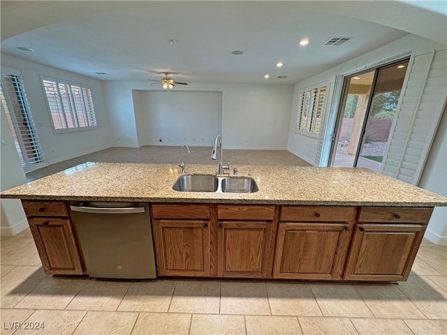 kitchen featuring light stone countertops, sink, plenty of natural light, and dishwasher