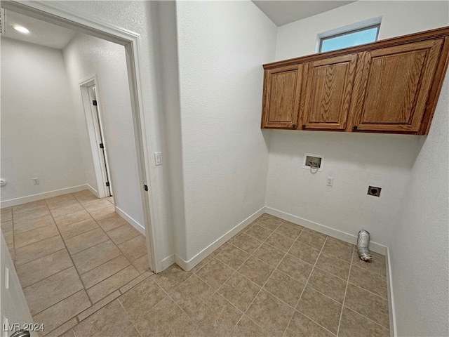 washroom with electric dryer hookup, washer hookup, and light tile patterned floors