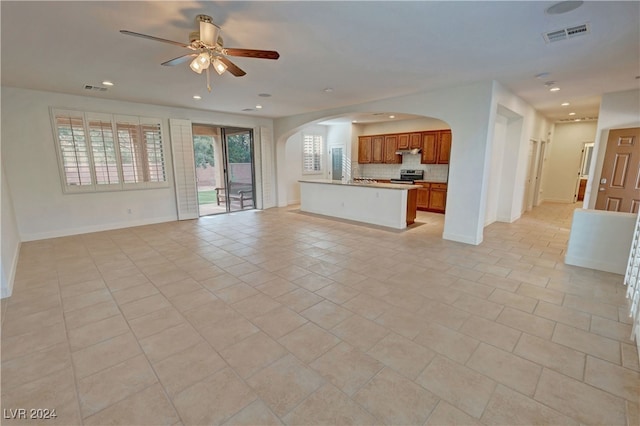 unfurnished living room with ceiling fan and light tile patterned floors