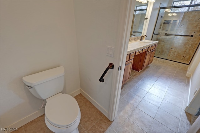 bathroom featuring vanity, an enclosed shower, toilet, and tile patterned flooring