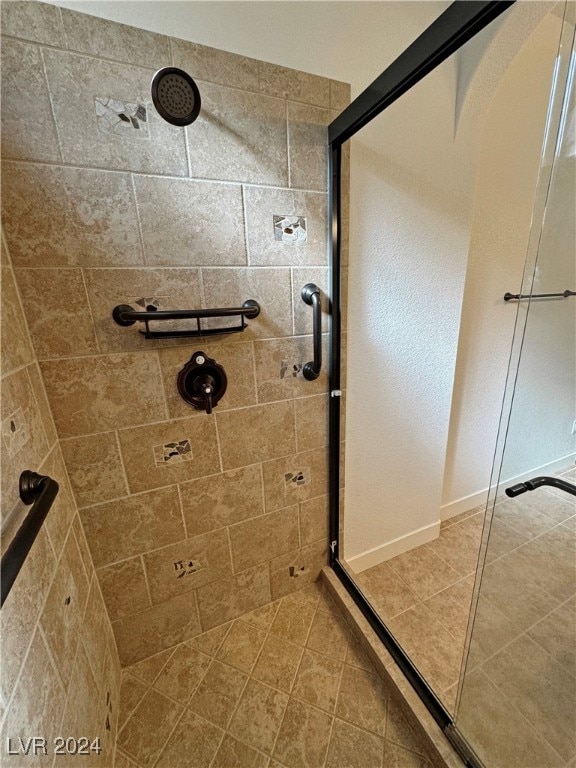 bathroom featuring tile patterned flooring and an enclosed shower