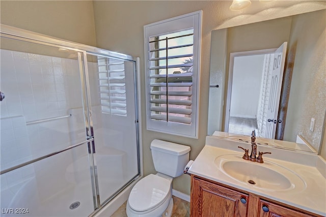 bathroom with vanity, toilet, and walk in shower