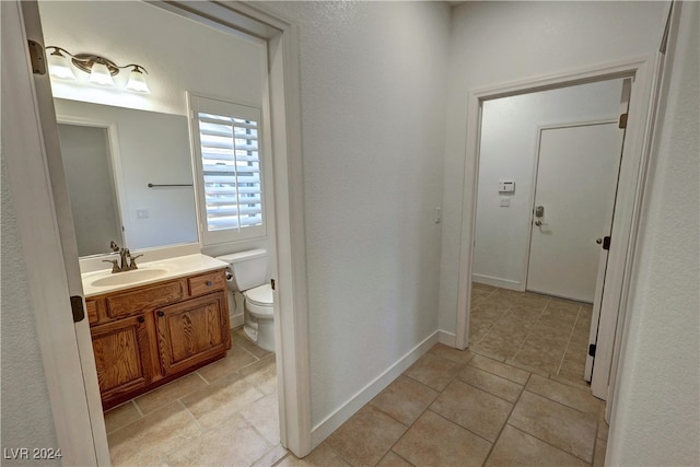 bathroom with vanity, toilet, and tile patterned flooring