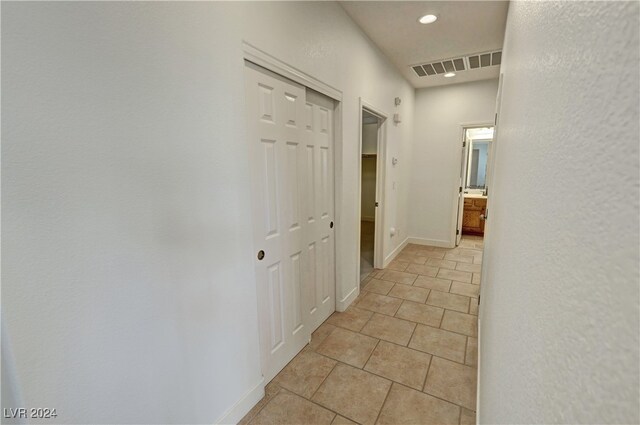 hall featuring light tile patterned flooring