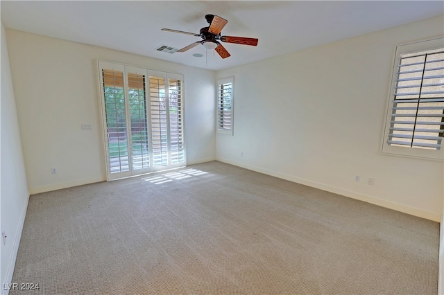 carpeted empty room featuring ceiling fan