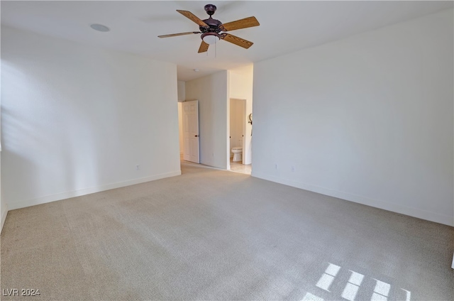 carpeted spare room with ceiling fan