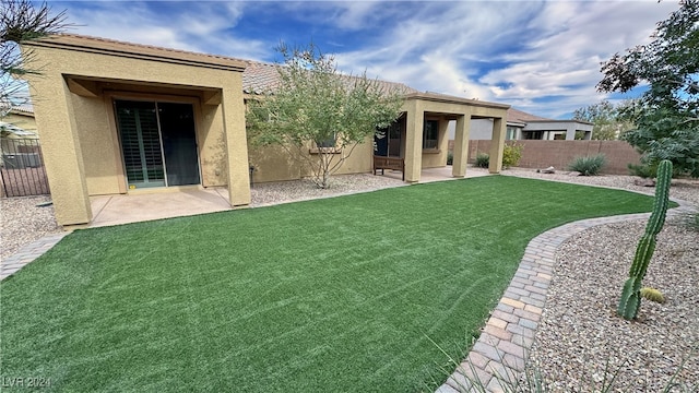 rear view of property featuring a patio and a lawn