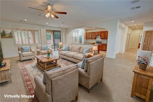 tiled living room featuring ceiling fan