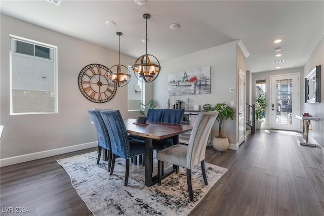 dining room featuring an inviting chandelier and dark hardwood / wood-style flooring