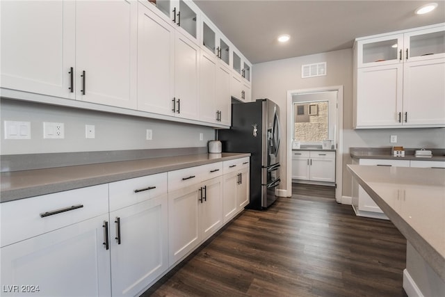 kitchen featuring stainless steel fridge with ice dispenser, white cabinetry, and dark hardwood / wood-style flooring