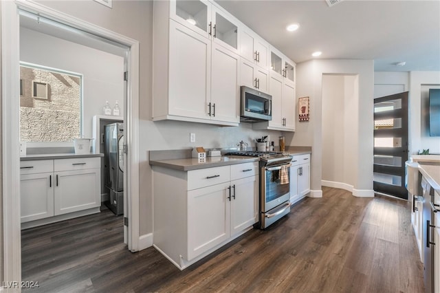 kitchen with dark wood-type flooring, appliances with stainless steel finishes, and white cabinets