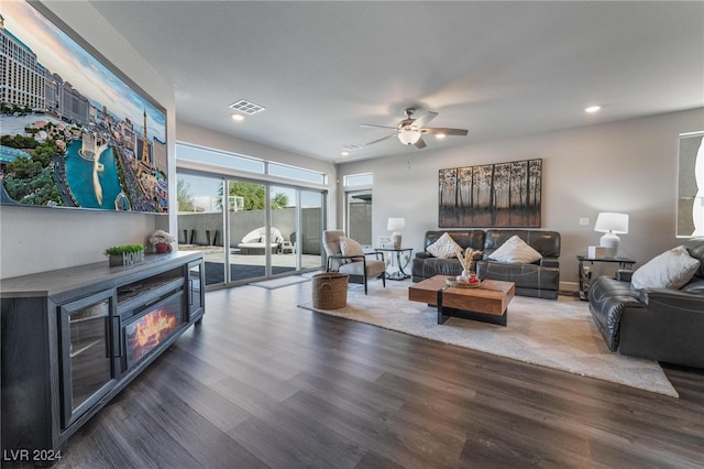 living room with ceiling fan and dark hardwood / wood-style flooring