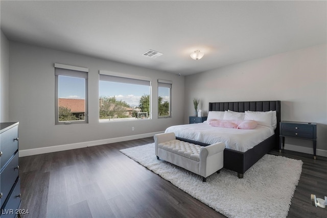 bedroom with dark hardwood / wood-style floors