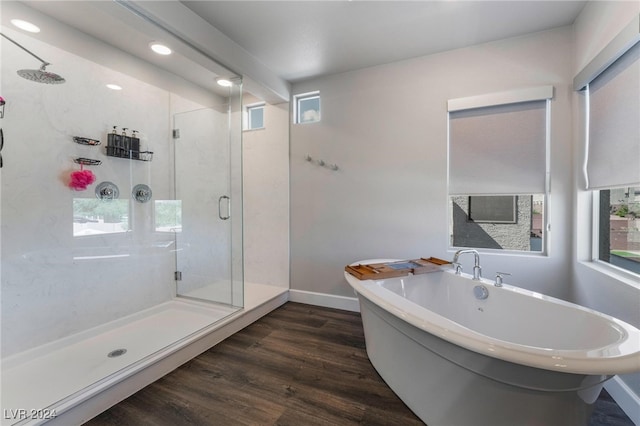 bathroom featuring shower with separate bathtub and hardwood / wood-style floors