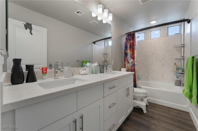 full bathroom featuring vanity, wood-type flooring, toilet, and shower / bathtub combination with curtain