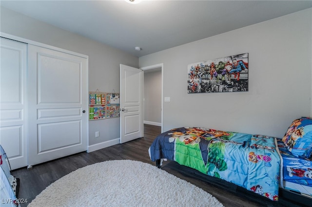 bedroom with a closet and dark hardwood / wood-style flooring