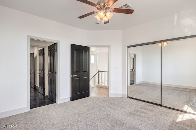 unfurnished bedroom featuring carpet, a closet, and ceiling fan