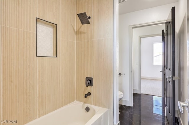 bathroom with toilet, bathing tub / shower combination, and tile patterned flooring