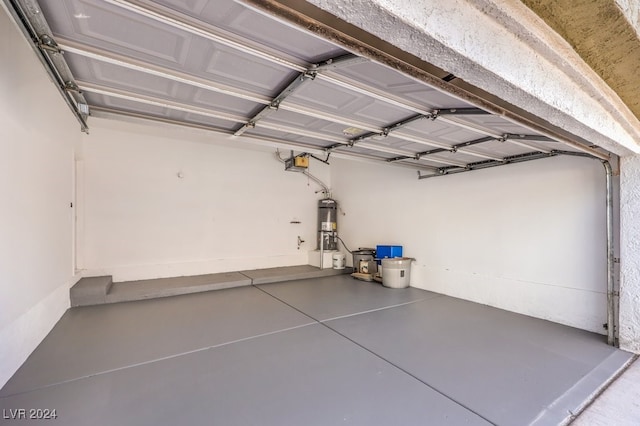 garage featuring a garage door opener and secured water heater