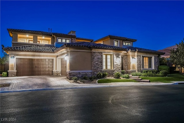 mediterranean / spanish-style home featuring a garage