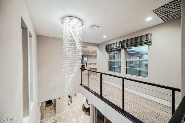 hallway featuring a chandelier