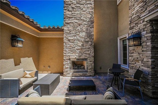 view of patio featuring an outdoor living space with a fireplace