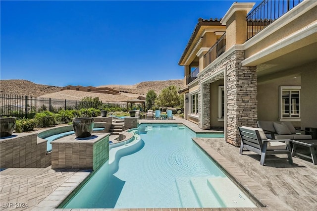 view of swimming pool with a mountain view and a patio