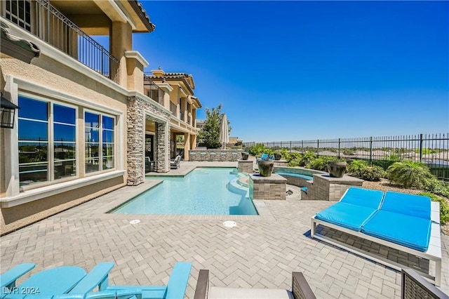 view of swimming pool featuring an in ground hot tub and a patio