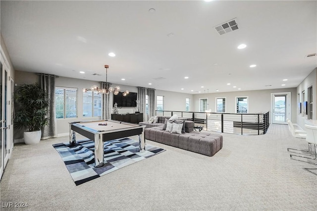 carpeted living room featuring a notable chandelier and pool table