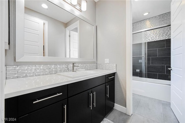 bathroom with decorative backsplash, vanity, tile patterned floors, and tiled shower / bath