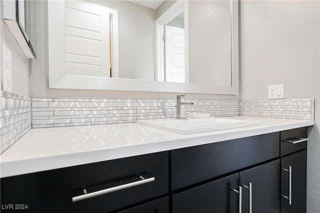 bathroom featuring decorative backsplash and vanity