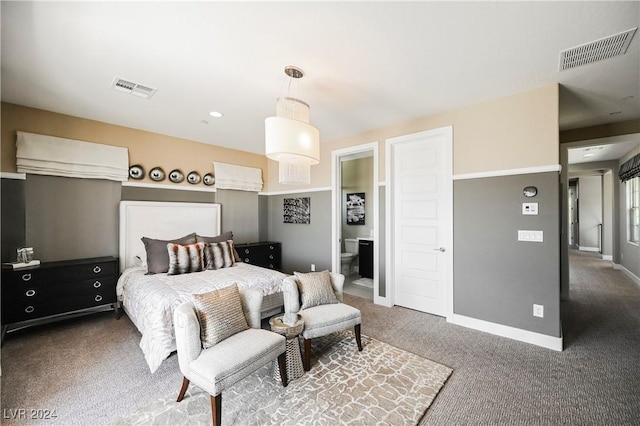 bedroom featuring connected bathroom and dark carpet