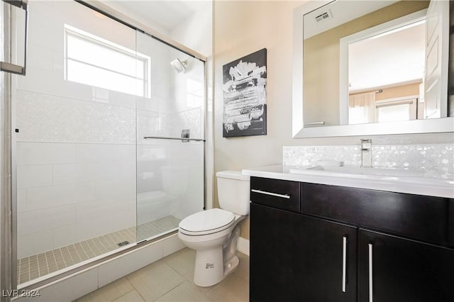 bathroom with tile patterned floors, vanity, toilet, and plenty of natural light