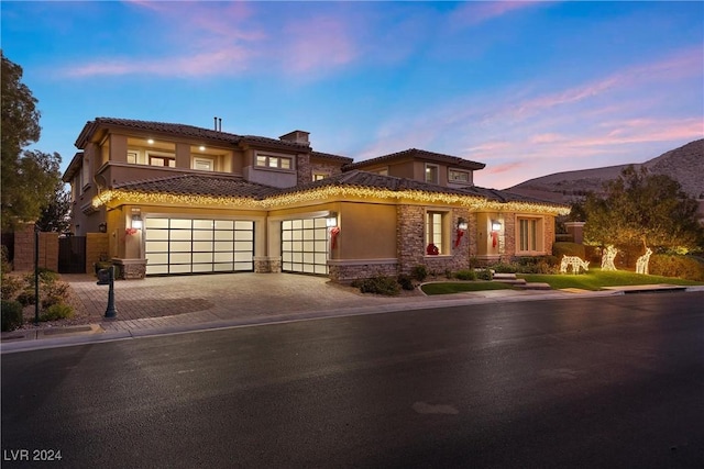 view of front of house with a mountain view and a garage