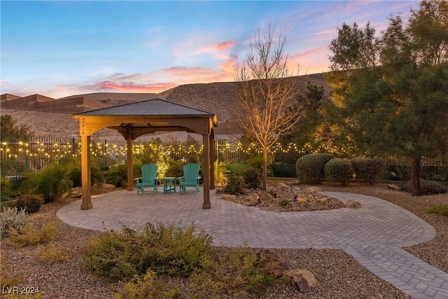 patio terrace at dusk featuring a gazebo