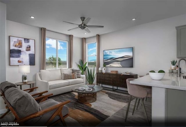 living room featuring sink and ceiling fan