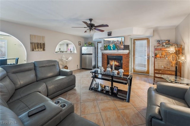 living room with ceiling fan, light tile patterned floors, and a fireplace