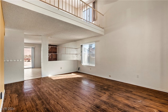 empty room featuring wood-type flooring and a textured ceiling