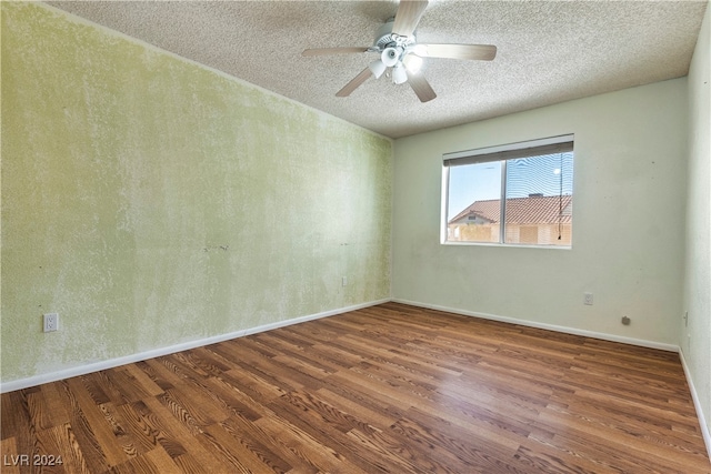 spare room with ceiling fan, a textured ceiling, and hardwood / wood-style floors