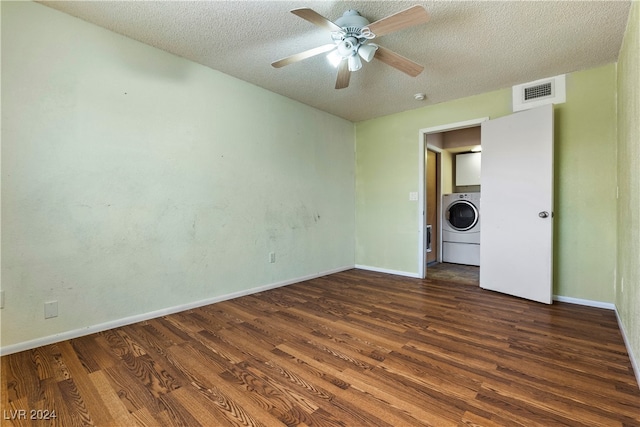 spare room featuring washer / dryer, ceiling fan, a textured ceiling, and dark hardwood / wood-style flooring