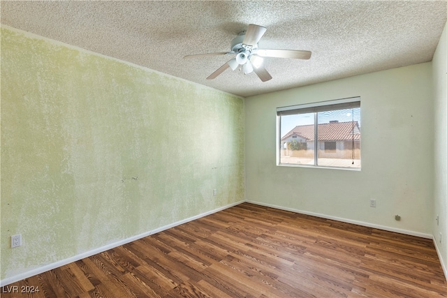 unfurnished room with dark wood-type flooring, ceiling fan, and a textured ceiling