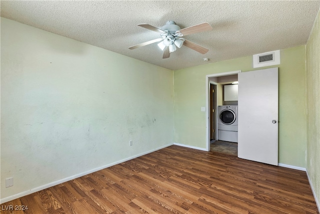 spare room with dark wood-type flooring, ceiling fan, washer / dryer, and a textured ceiling