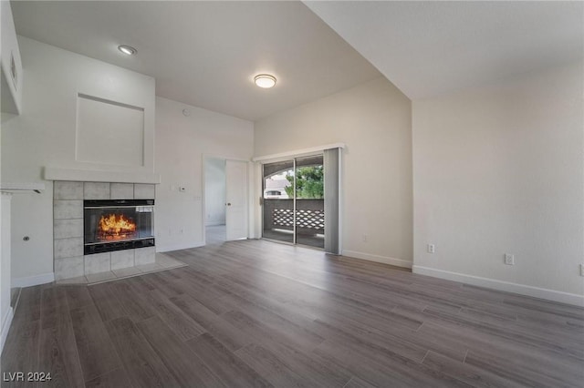 7400 W Flamingo Rd Unit 2013, Las Vegas, NV 89147 - unfurnished living room with a fireplace, dark wood-style floors, and baseboards